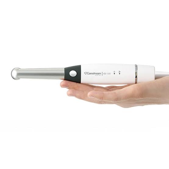 Carestream CS1500 intraoral camera held in hand for dental examination and diagnostics