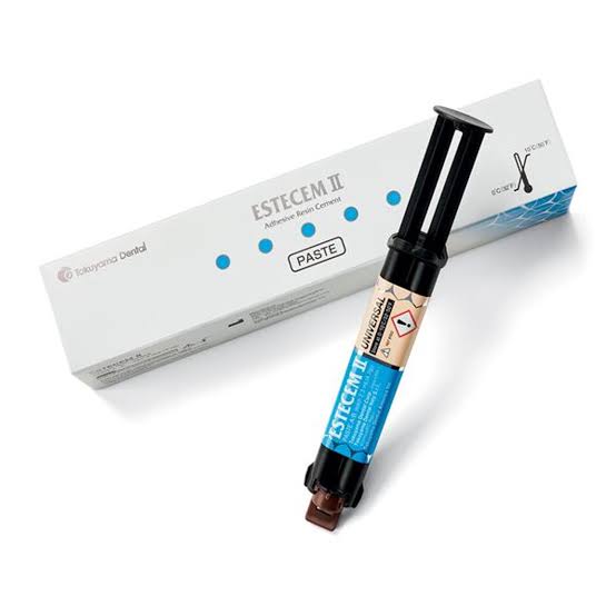 Tokuyama EsteCem II Plus self adhesive resin cement syringe with packaging for dental use