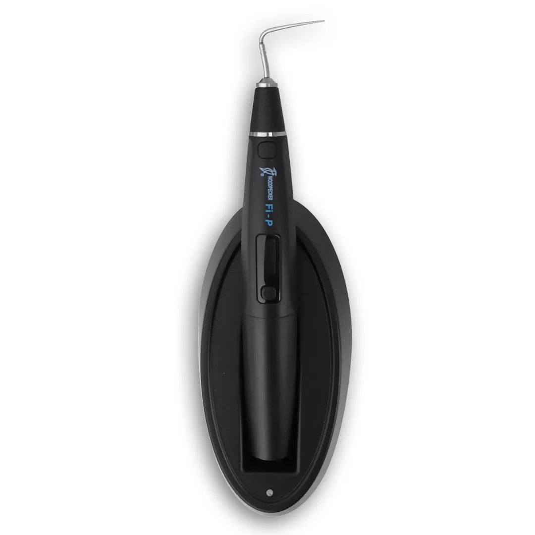 Woodpecker Obturation Pen for dentists. Black cordless obturation pen with angled metal tip on oval charging base